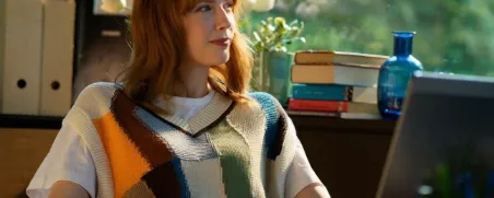 Junge Frau ist entspannt, weil sie mit der R+V-BasisRente Safe+Smart vorgesorgt hat. 