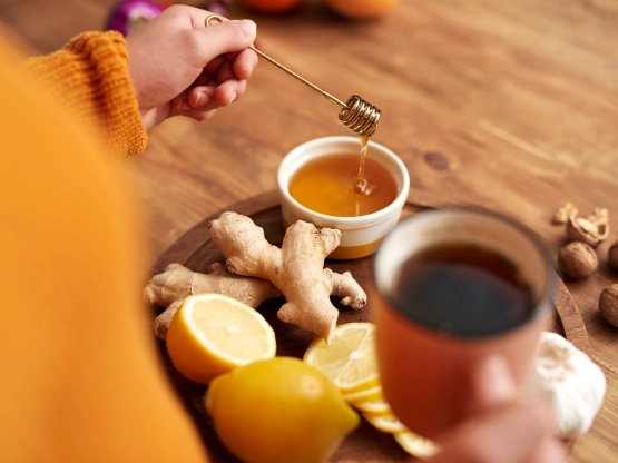 Teetasse mit Honig und heißer Zitrone und Ingwer.