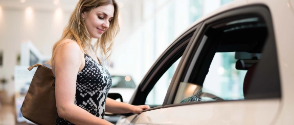 Junge Frau beim Autokauf.