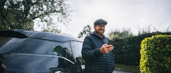 Ein Mann freut sich über die THG-Prämie für sein Elektroauto.