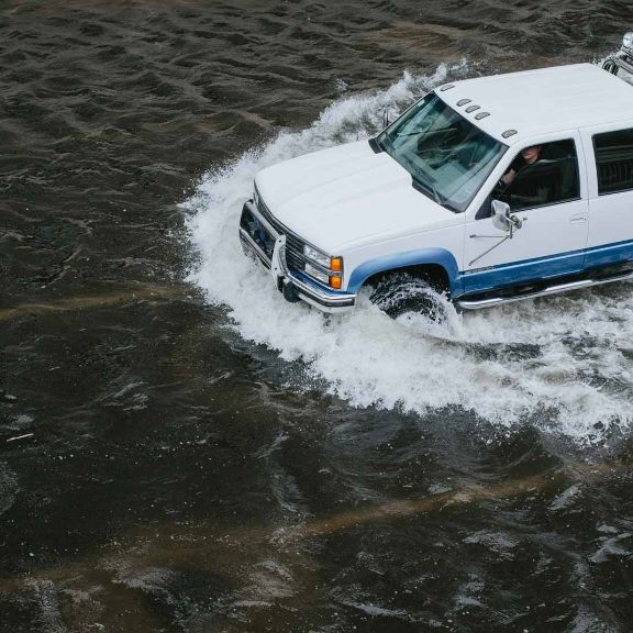 Hochwasser Auto fährt durch Hochwasser